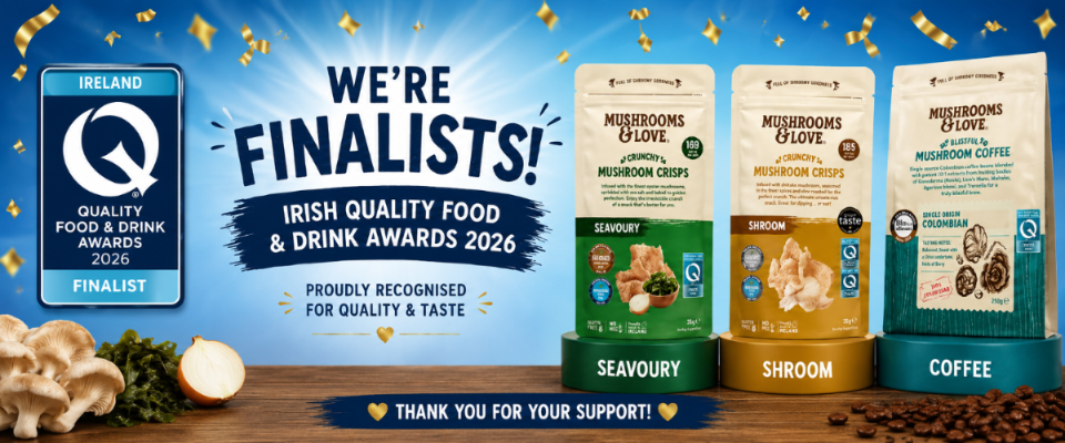 Two pouches of Mushroom Crisps & a pouch of Blissful Coffee are displayed on a wooden surface with coffee beans and mushrooms. The background is a blue graphic with gold confetti and text celebrating the Irish Quality Food & Drink Awards 2026 Finalists.